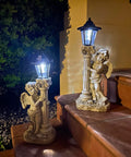 Lit Solar Angel Garden Statue With Roma Pillar for Outdoor Decor and Lawn or Patio, 19.7 in, left facing, night scene