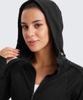 Woman in Cozy Womens Fleece Full Zip Hoodie With Thumb Holes Black Hip Length Go To Casual Sweatshirt Jacket, hood on.