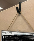 4 Pack Adjustable Cubicle Hooks For 1.8 To 3.5 Inch Panels And Walls, Plastic Coat Hooks For Laptops, Bags, Cases, And Coats, Sturdy Hangers With Easy Install, Style 1 Black clipped to cubicle wall holding a board.