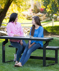 Two people sitting and talking at Outdoor Convertible Bench To Table In Seconds 55 Inch Harbor Gray Weather Resistant Polystyrene Slats.