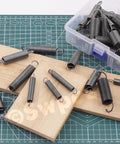 Solid Carbon Steel Spring Assortment Kit With 250 Piece Count Featuring 5 Versatile Compression Sizes For Heavy Duty Repairs And DIY Projects To Keep Your Gear Running Smooth And Tough Out There., carbon steel springs in plastic box on work mat