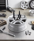 Universal Wheel Bolt Pattern Gauge For 4 5 6 8 Lug Wheels with inch and metric readings measuring wheel lug spacing on a silver wheel.