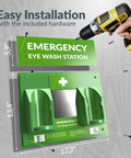 Front view of green wall-mounted emergency eye wash station with twin rinse cups, mirror panel, and mounting hardware