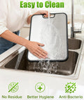 Two In One Titanium Cutting Board For Kitchen With Double Sides in a sink being rinsed; easy to clean with text on cleaning benefits.