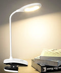 Clip On LED Desk Lamp With Battery Power Cordless Bedside Light illuminating books on a table with flexible arm and clamp