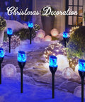 Solar Outdoor Lights 6 Pack Tiki Torches With Flickering Flame illuminating a snowy garden path with blue light decorations