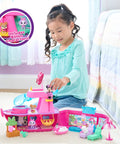 Child playing with Minnie Mouse Bowdazzling Yacht Lights And Sounds Playset With 16 Piece Figures And Accessories Pink Boat