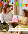 Woman and child exchanging a gift with Watering Can Lantern Lights Solar Outdoor Garden Decor visible on a table