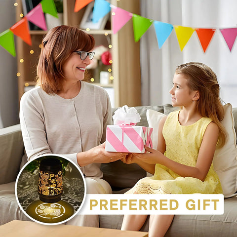 Woman and child exchanging a gift with Watering Can Lantern Lights Solar Outdoor Garden Decor visible on a table