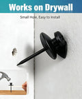 Sleek Double Headed Picture Hanging Nails For Drywall Renter Friendly Push Pins With Hand Protector Set Of 50 All Black Thumb Tacks embedded in drywall.