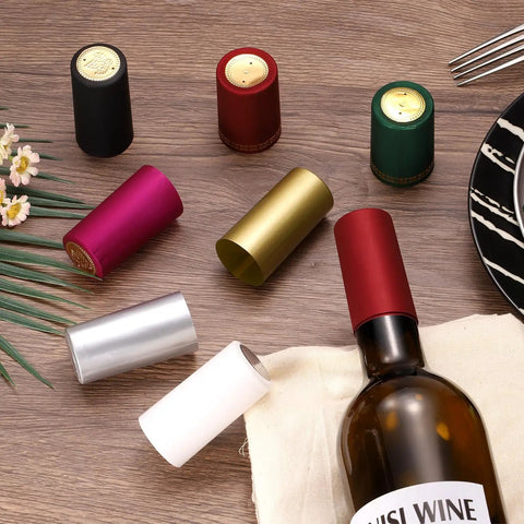 Premium Black Heat Shrink Bottle Caps For Wine And Spirit Sealing With No Sweat Party Wraps For Oil Jars And Crafts Heavy Duty Plastic Sealer Bulk Pack Of Two Dozen Units That Lock Tight For Home Use, displayed with various colors.