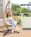 Woman sitting in Egg Chair With Stand Outdoor Patio Wicker Hanging Chair Hammock Swing Seat Cozy Ergonomic Design With Thick Cushion
