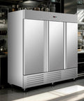 Badass Commercial Upright Freezer With Three Doors featuring stainless steel design in a modern kitchen with rolling wheels.