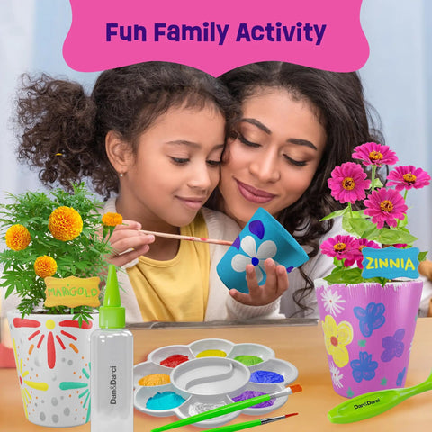 Mother and child painting pots from Paint And Plant Stoneware Flower Garden Kit For Kids 6 To 12 with marigold and zinnia flowers displayed
