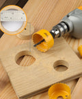 Close-up of Six Piece Hole Saw Set With Arbor Adapter Makes Short Work Of Wood Metal Plastic Drywall Cutter Kit in use on wood.
