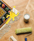 No Fuss Paint Edger Roller Brush Set With Replacement Pad And Quick Rinse Bristles For Walls, yellow roller on wood floor.