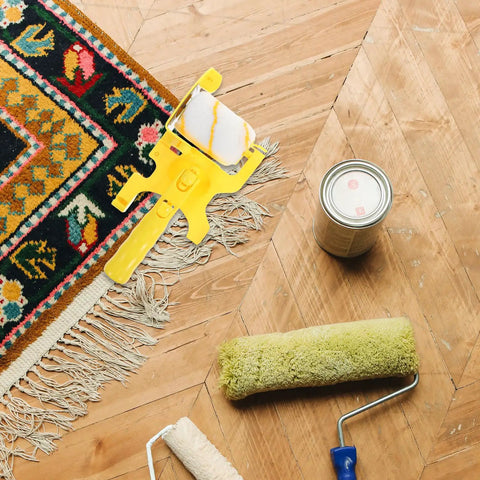 No Fuss Paint Edger Roller Brush Set With Replacement Pad And Quick Rinse Bristles For Walls, yellow roller on wood floor.