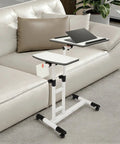 Smooth Rolling Standing Desk Heavy Duty Sit Stand Laptop Cart Adjustable Height with lockable wheels in a modern living room.