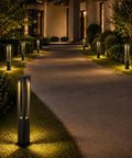 Modern Black LED Pathway Lights Sleek Cone Bollards illuminating a curved path in a garden setting with warm glow.