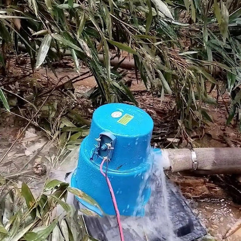 Blue 500W Portable Hydroelectric Generator 220V Water Turbine With Pure Copper Coil in forest setting, water flowing through.