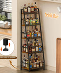 Roomy 5 Tier Trapezoid Liquor Cabinet For Home Bar Space beefy freestanding wine rack filled with various liquor bottles in a kitchen.