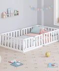 Twin Size Solid Wood Montessori Floor Bed Frame With Secure Guard Rail And Playful Front Door Design in a cozy bedroom.