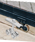 Close-up of Heavy Duty Sliding Door Roller Kit With Galvanized Track Pulley, installed on industrial gate under track.