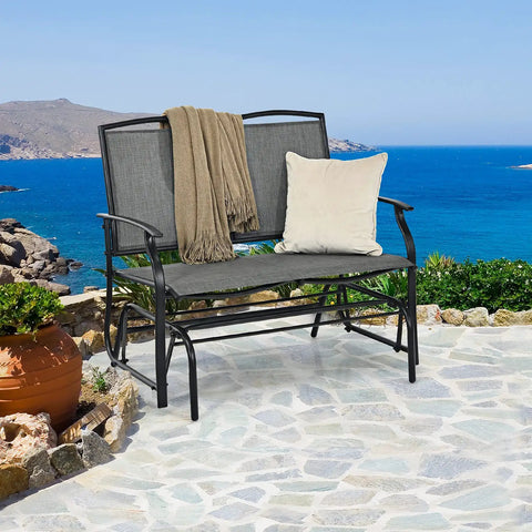 Outdoor Glider Bench For Patio And Backyard With Steel Frame That Handles 400 Lbs Two Person Loveseat Swing Rocker Great For Poolside Lawn Balcony And Porch Hangouts Gray on stone patio by sea