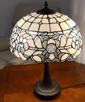 Vintage Tiffany Style Stained Glass Table Lamp 22 Inch Tall with White and Gray Mahogany Floral Shade on Wooden Table