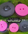Two Heavy Duty XXL Collapsible Camping Stools in cushioned carry bags, one pink and one black, shown for size comparison on grass.