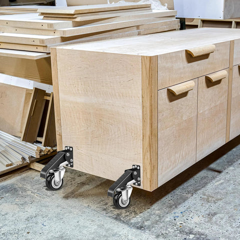 Wooden workbench with Heavy Duty Workbench Casters Kit 600 Lb Capacity Set of 4 attached, in a workshop setting