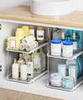 Super Handy Two Tier Under Sink Organizers And Bathroom Storage Solutions For Cabinets And Kitchen Pantries With Smooth Slide Out Drawers And Fully Adjustable Dividers In Bright White Two Pack displaying toiletries and towels.