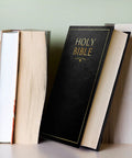 Hidden Bible Safe Box With Combination Lock For Discreet Stash resting among real books on a bookshelf