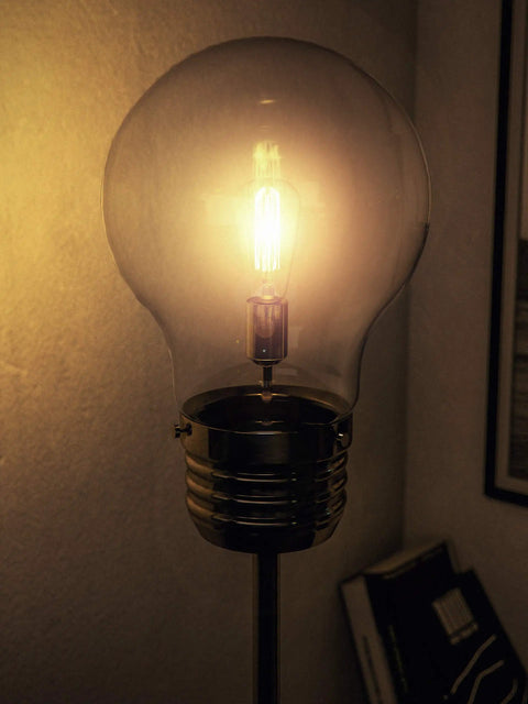 Close-up of vintage LED Edison bulb in glass shade of Edison Floor Lamp In Antique Brass Finish, Rustic Vibe, 71.5 Inch Tall