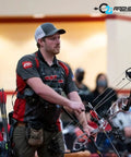 Archer preparing to shoot an arrow with compound bow, using Fusion-II 2.1 Inch Pink Arrow Fletching Vanes, 36 Pack, in competition.