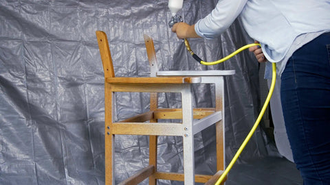 Person using HVLP Gravity Feed Spray Gun For Auto And Home Garage Projects, Furniture, And Equipment Painting With 600 mL Cup