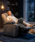 Woman relaxing in Power Lift Chair Massage Recliner for Seniors with Ergonomic Support in a cozy living room setting, gray color.