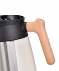 Close-up of 12 Cup Glass Carafe Replacement for CFP301 CM300 CM401 Coffee Makers showing beech wood handle and filter.