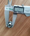 Two silver hydraulic hose fitting adapters (14H to 18ED) held in calipers.
