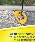 Jumbo Debris Dustpan with 36-inch steel handle, holding debris on asphalt, showcasing swiveling pan with snap lock, ergonomic grip.