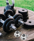 Two Pack Barbell Collar Clamps For Dumbbells And Fitness Gear, Screw Lock Design on weights and kettlebell on a wooden table
