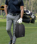 Golf Shoe Bag With Zipper Pocket And Padded Carry Strap For Easy On The Go Golf Gear held by golfer on course