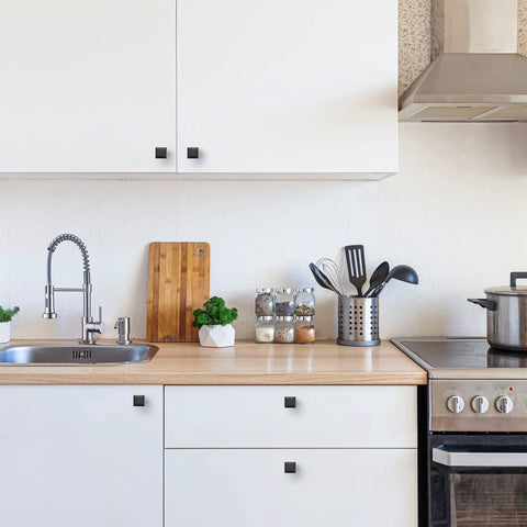 Matte Black Square Cabinet Knobs 15 Pack 1 Inch Diameter Zinc Solid Drawer Pulls in modern kitchen setting.
