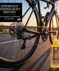 Close-up of a road bike in motion with Gold Bike Chain Lube 4oz Two In One Clean And Lubricates For Road Track MTB And BMX.