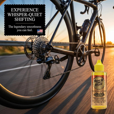 Close-up of a road bike in motion with Gold Bike Chain Lube 4oz Two In One Clean And Lubricates For Road Track MTB And BMX.
