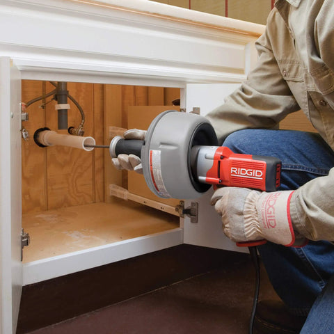K-45AF Air Powered Drain Cleaner 230V Drum Auger for Swage Lines and Sewer Pipes in use under a sink.