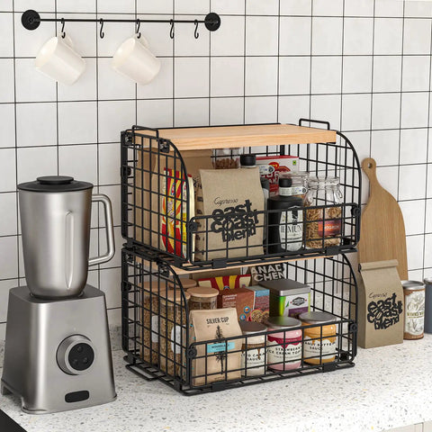Keep Your Counters Tight With This Solid Stackable Wire Basket Set Designed To Sweep Up Kitchen Clutter While Offering Plenty Of Room For Sorting Fresh Produce Spices And Snacks, showcasing two black wire baskets with wood tops on a kitchen countertop.