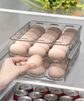 Person grabbing egg from Two Tier Clear Egg Organizer For Refrigerator, 36 Egg Capacity, Auto Rolling Tray System, BPA Free