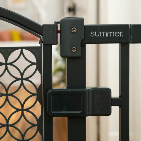 Close-up of latch on gray walk through baby and pet gate easy to use for doorways and stairways no drill pressure mount