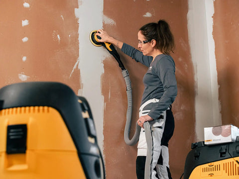Top Tier 6 Inch Random Orbital Sander Featuring A Smooth Brushless Motor And Effective Dust Extraction in use for drywall sanding.
